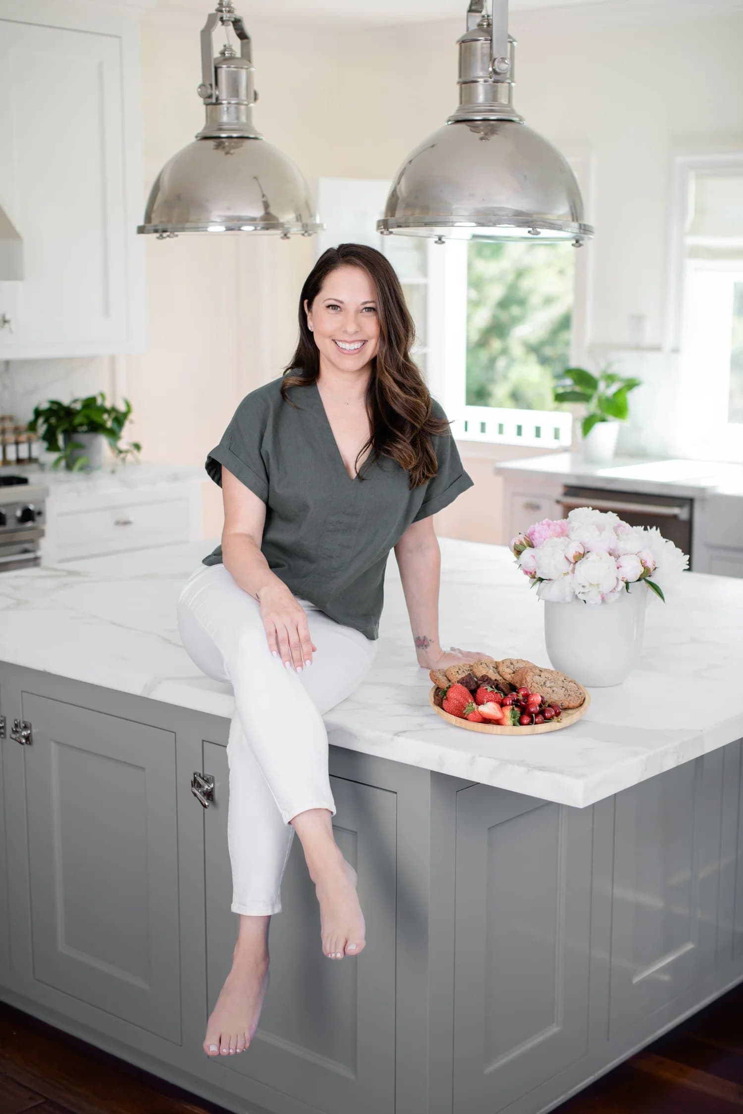 Sarah Schier, founder of Beautiful Life Creative Organizing, in a bright client kitchen